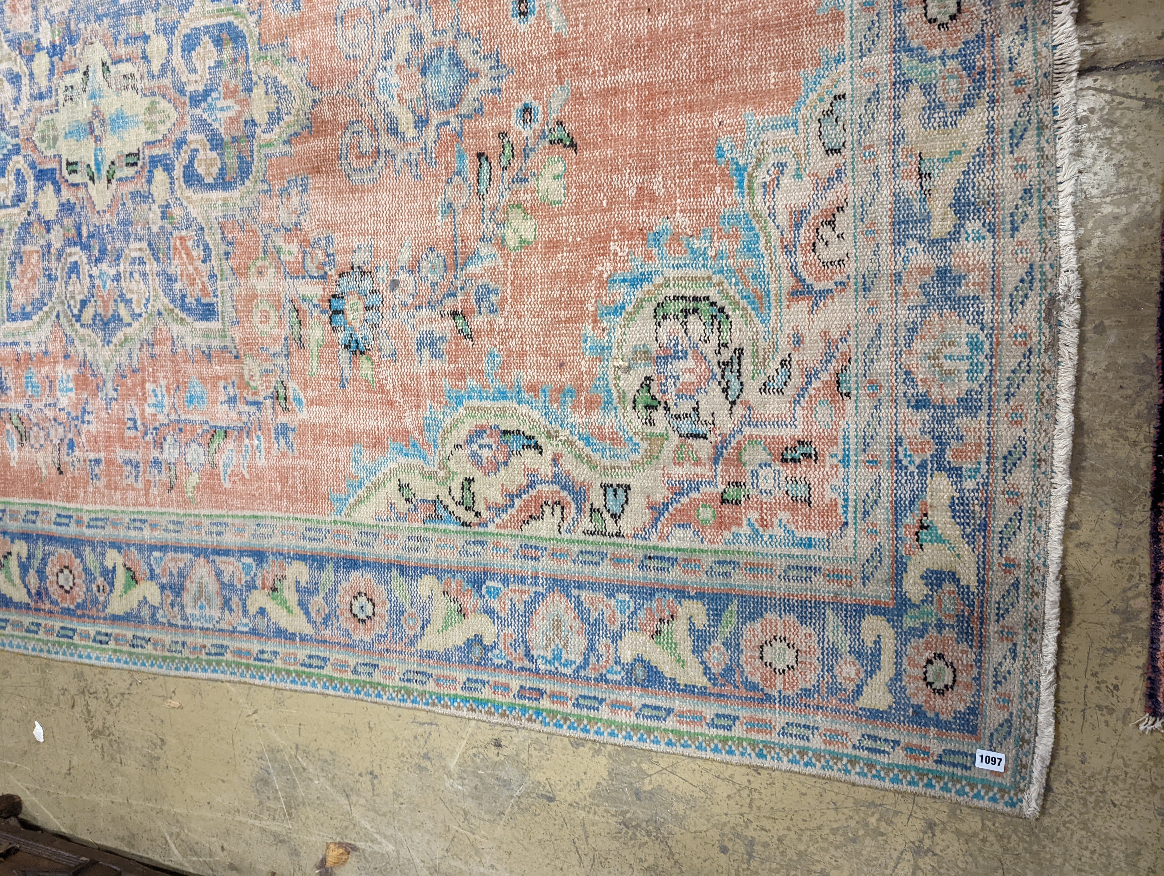 A North West Persian style faded wool carpet, 300 x 196cm